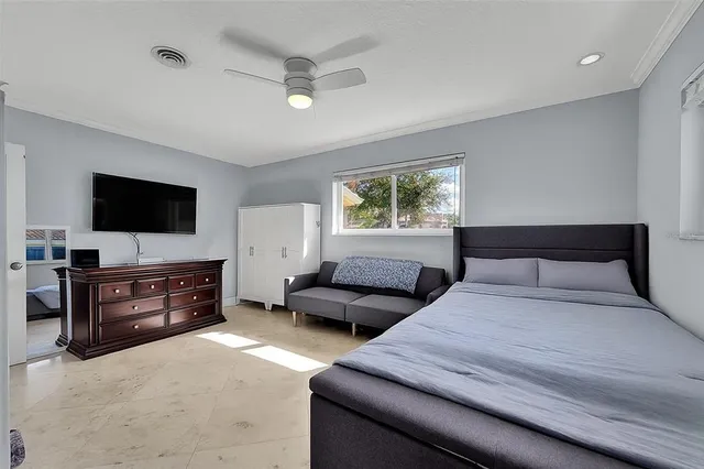 a bedroom with furniture and a flat screen tv