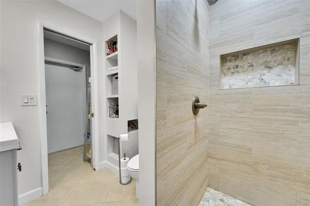 a bathroom with a toilet and a shower