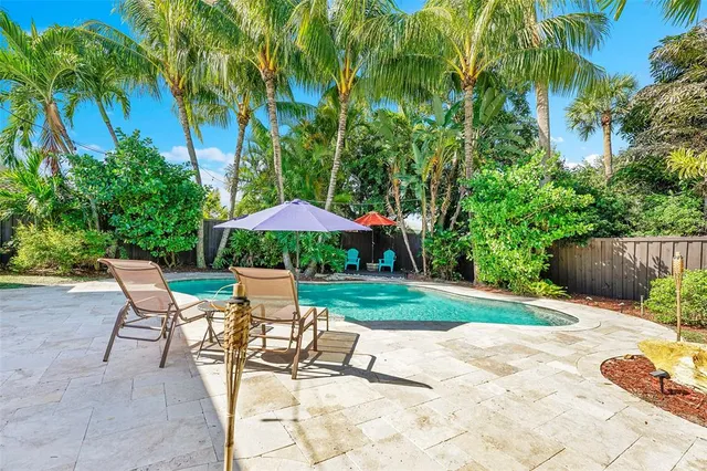 a view of backyard with outdoor seating and trees