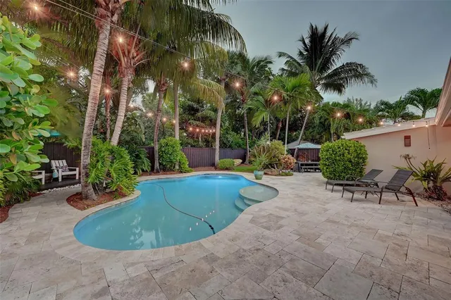 a view of a swimming pool with sitting area