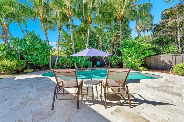 a lawn chair sitting under a blue umbrella