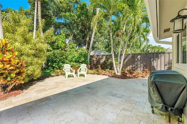 a view of backyard with outdoor seating and trees