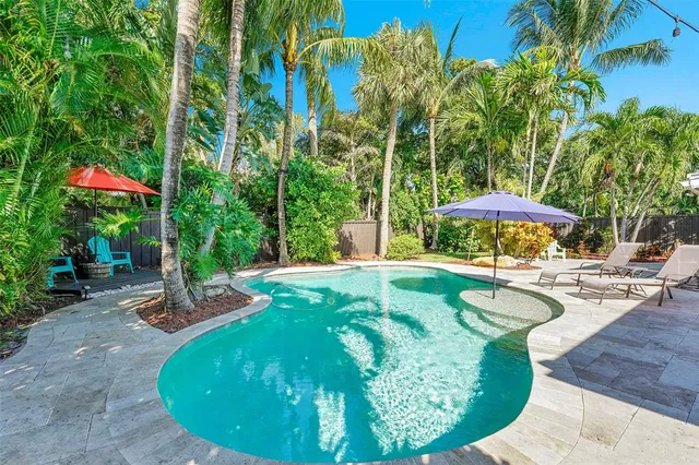 a swimming pool with outdoor seating yard and barbeque oven
