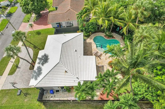 an aerial view of a house with a yard and potted plants
