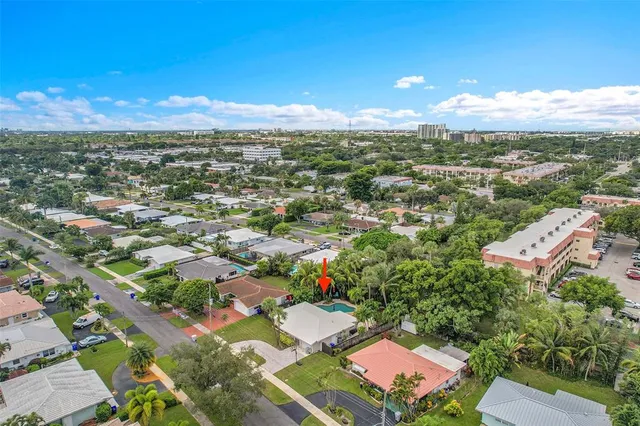 an aerial view of residential houses with outdoor space and street view