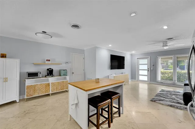 a large kitchen with a table and chairs in it