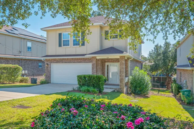 a front view of a house with a yard and fountain