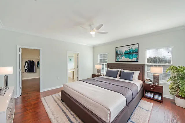 a bedroom with a large bed and a chandelier