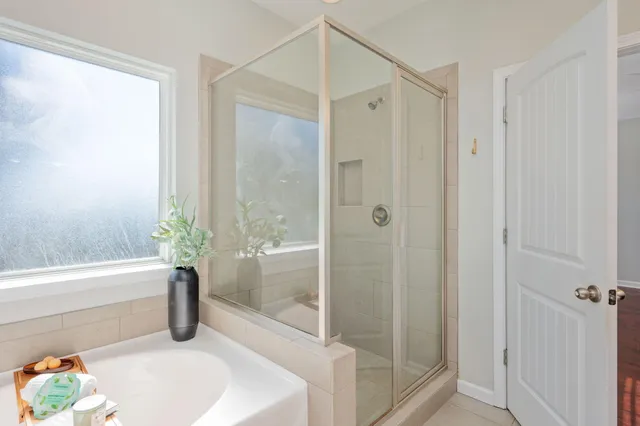a bathroom with a tub shower and toilet