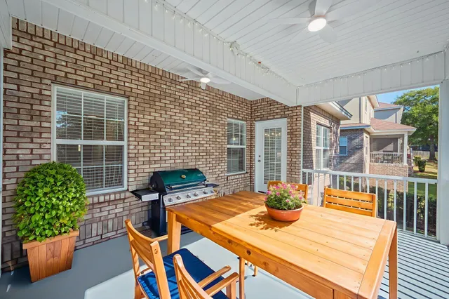 a view of a patio with table and chairs potted plants with wooden floor