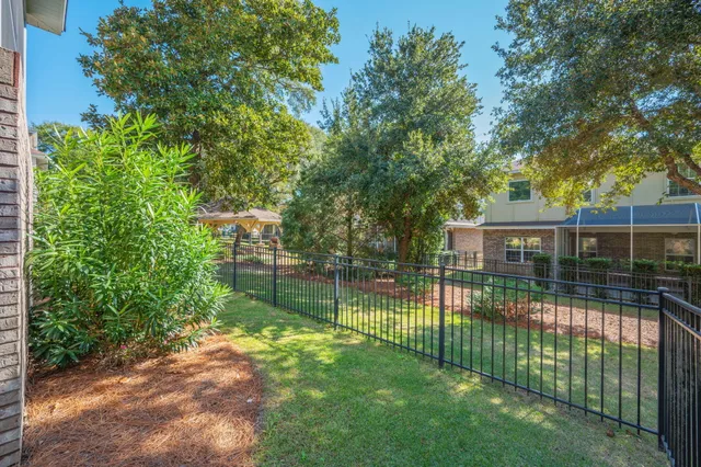 a view of a backyard with a garden and trees