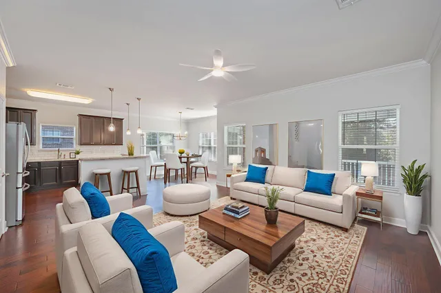 a living room with furniture a dining table and chairs