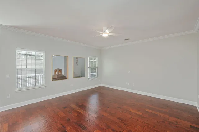 wooden floor in an empty room with a window
