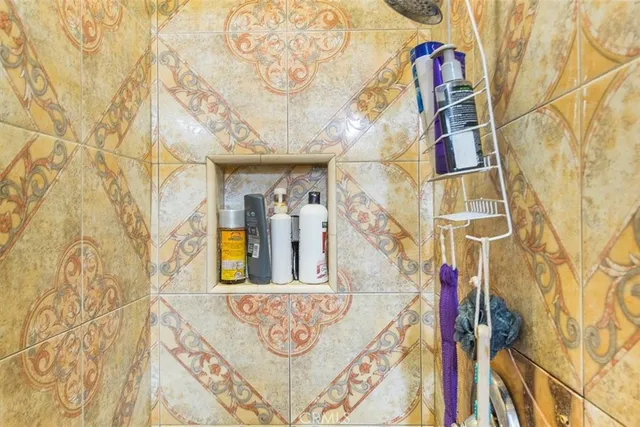 a bathroom with a granite countertop sink a mirror a vanity and a shower
