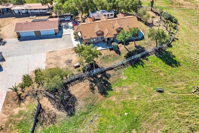 an aerial view of a house with a yard basket ball court and outdoor seating