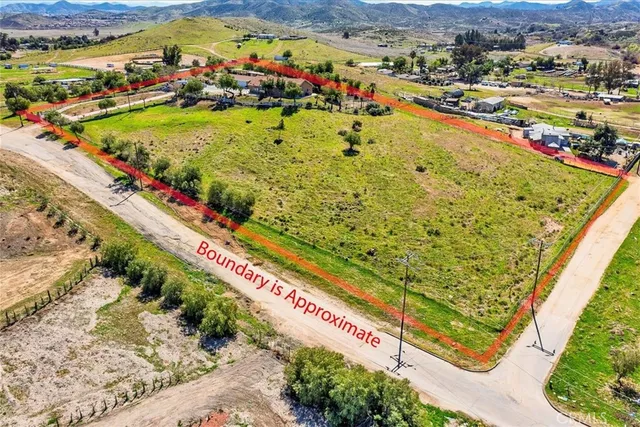 an aerial view of residential houses with yard