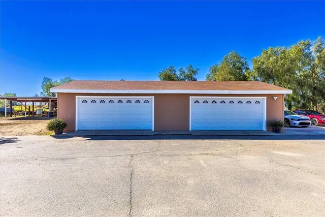 a view of a house with palm trees and a big yard