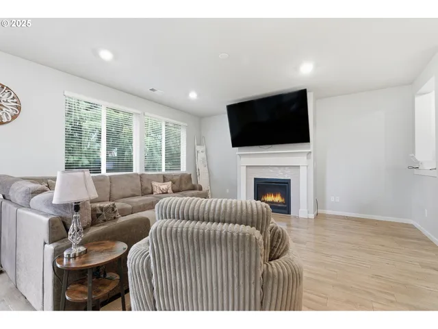 a living room with furniture and kitchen view
