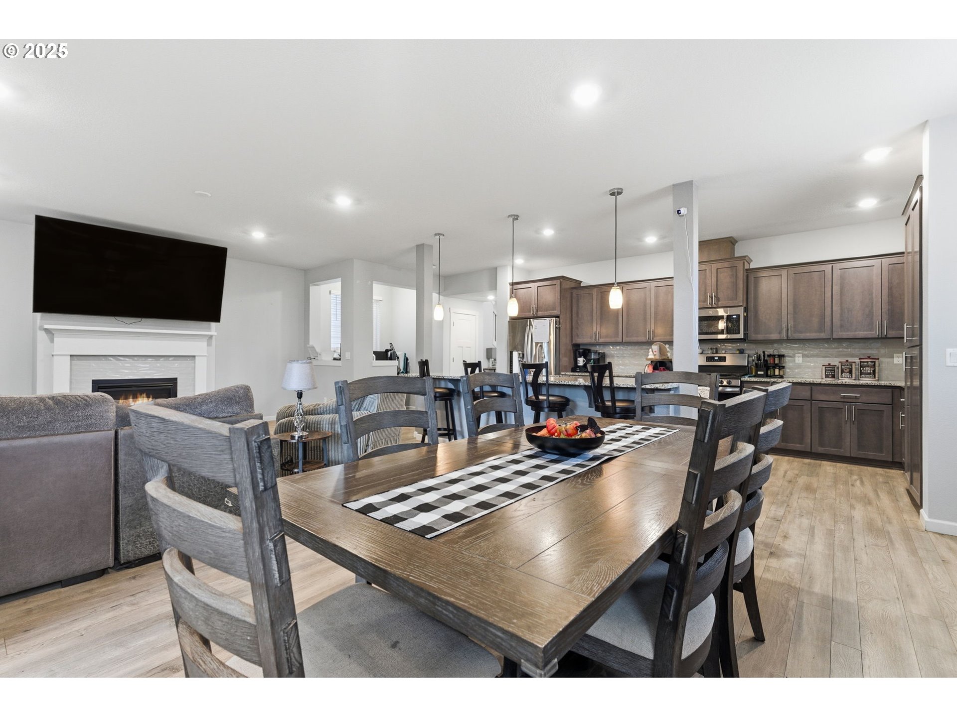 476 Southwest 15th Avenue Canby, OR 97013 - Photo 14 of 43 a kitchen with a dining table chairs stainless steel appliances and cabinets