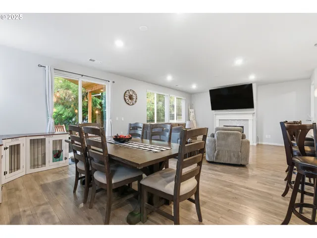 a open kitchen with kitchen island granite countertop a large counter top stainless steel appliances and a window