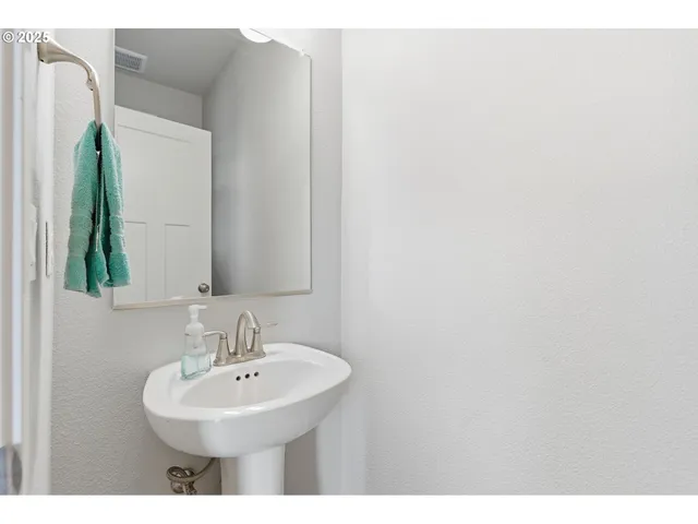 a bathroom with a tub shower and a sink