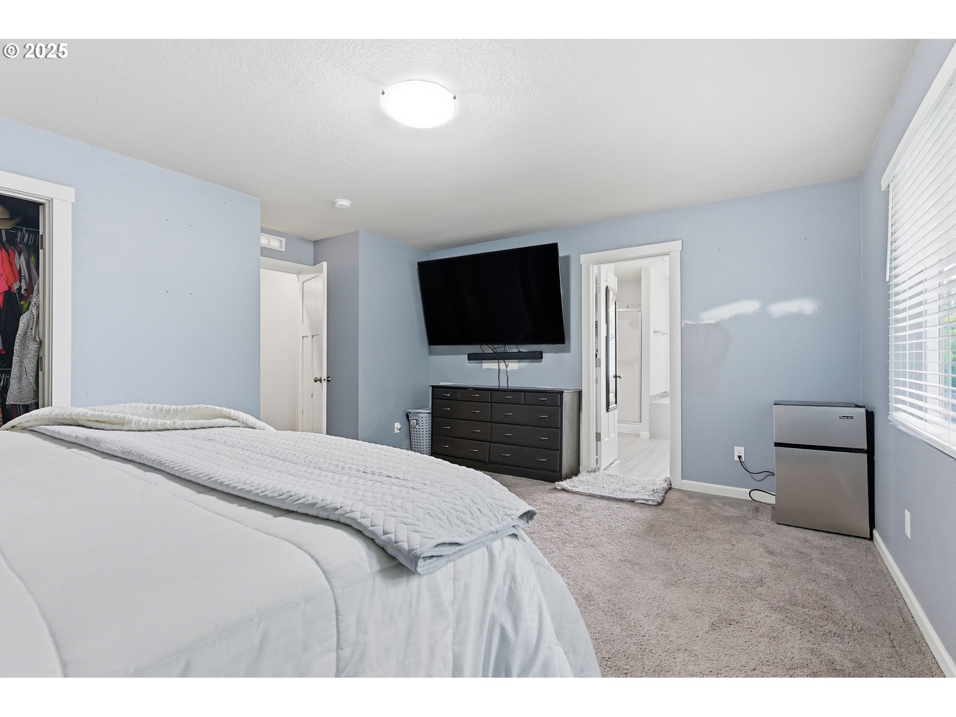 476 Southwest 15th Avenue Canby, OR 97013 - Photo 30 of 43 a bedroom with a bed and a flat screen tv