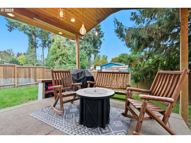 a view of a house with a yard and sitting area