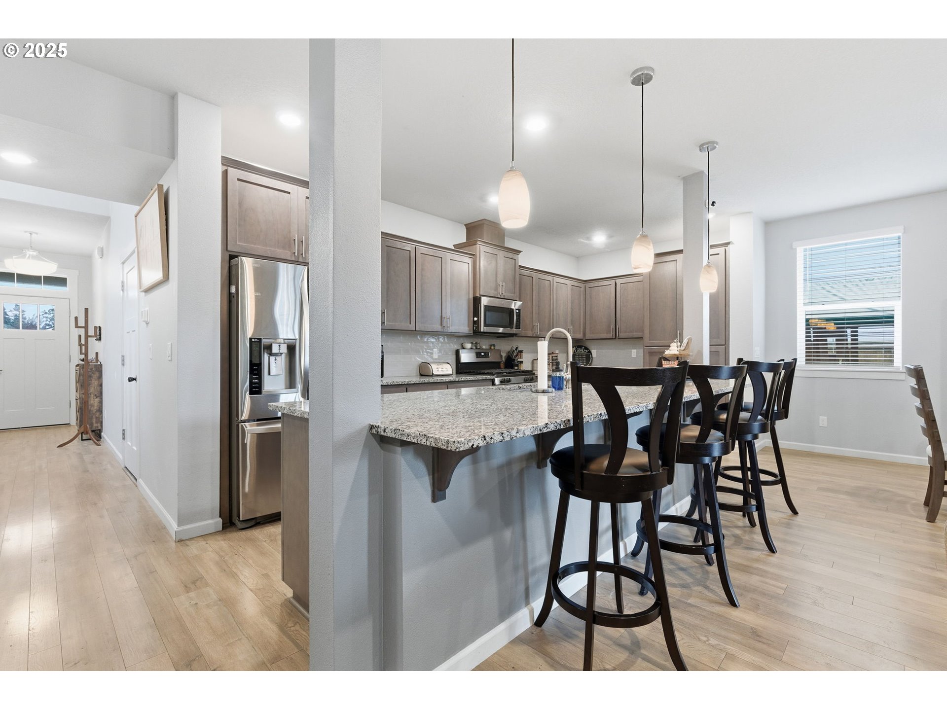 476 Southwest 15th Avenue Canby, OR 97013 - Photo 9 of 43 a kitchen with refrigerator and chairs