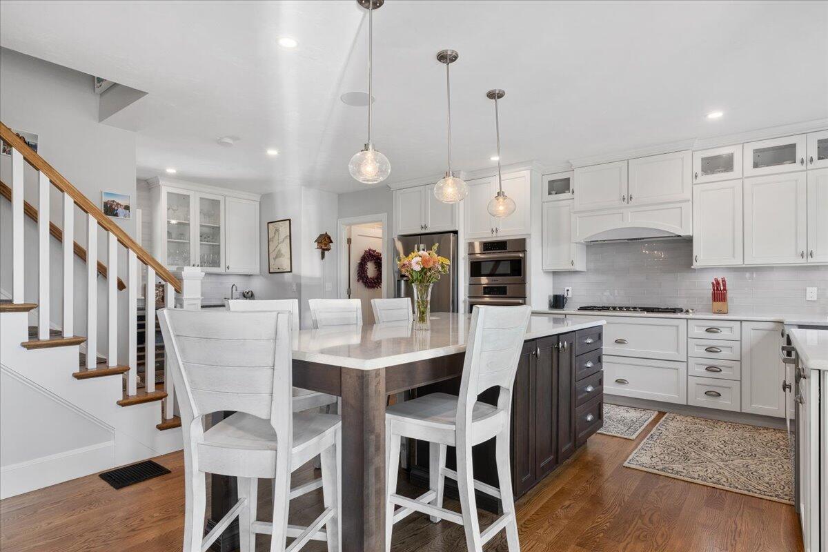 31 Amy Brown Road Mashpee, MA 02649 - Photo 14 of 95 a kitchen with stainless steel appliances kitchen island granite countertop a table chairs sink and cabinets