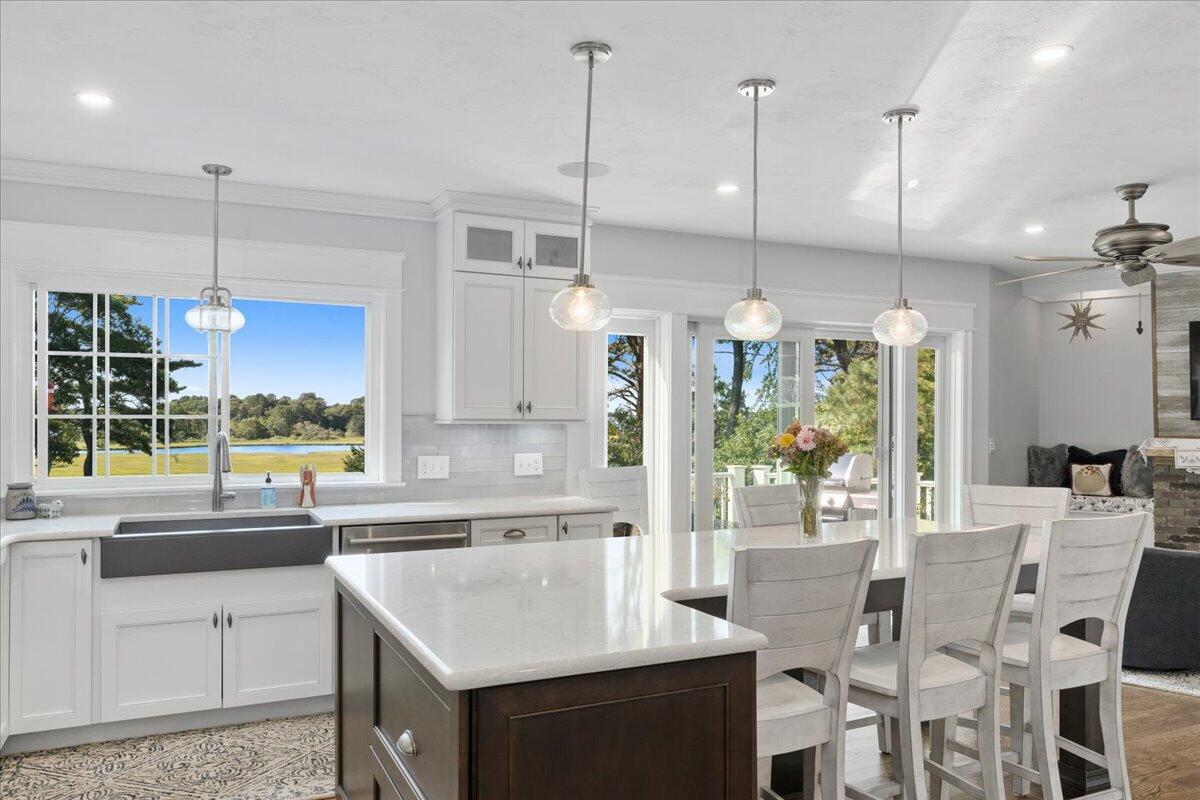 31 Amy Brown Road Mashpee, MA 02649 - Photo 17 of 95 a kitchen with stainless steel appliances kitchen island a table chairs and a sink