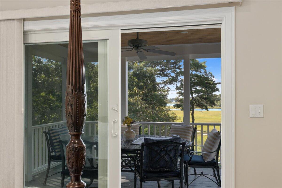 31 Amy Brown Road Mashpee, MA 02649 - Photo 26 of 95 a view of a porch with a table and chairs and potted plants