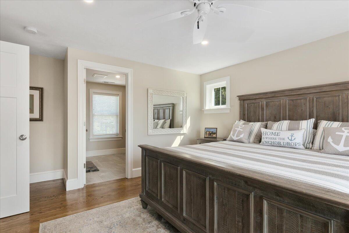 31 Amy Brown Road Mashpee, MA 02649 - Photo 46 of 95 a bedroom with a large bed and a wooden floor