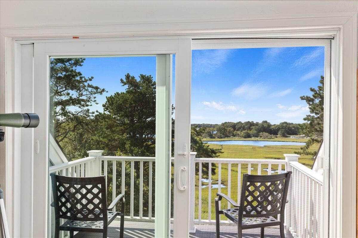 31 Amy Brown Road Mashpee, MA 02649 - Photo 53 of 95 a view of a balcony with lake view and a potted plant