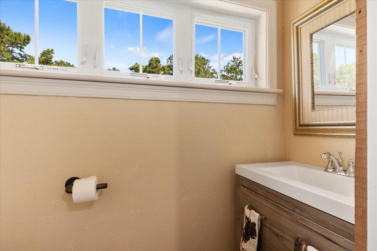 31 Amy Brown Road Mashpee, MA 02649 - Photo 59 of 95 a bathroom with a sink a mirror and a window