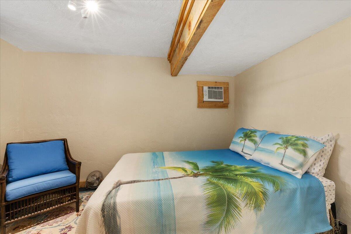 31 Amy Brown Road Mashpee, MA 02649 - Photo 60 of 95 a bed sitting in a bedroom next to a window