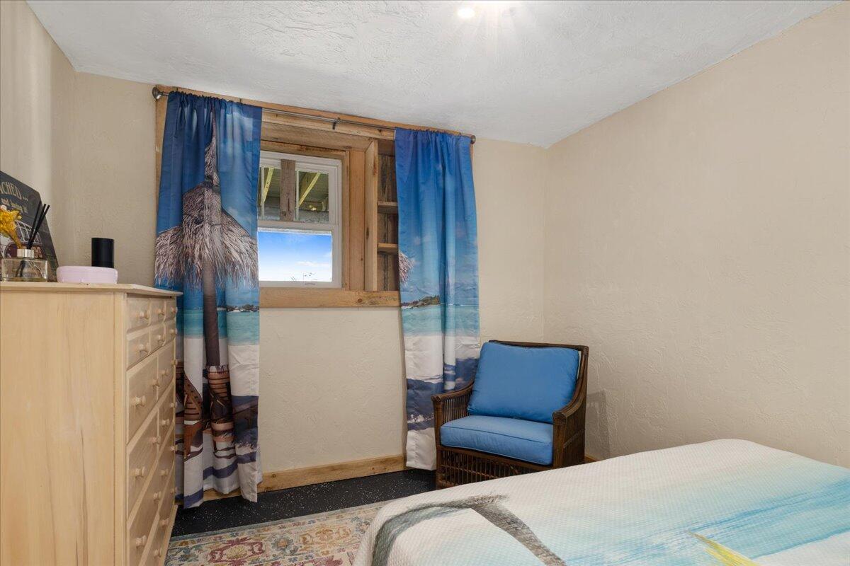 31 Amy Brown Road Mashpee, MA 02649 - Photo 61 of 95 a bedroom with a bed and a chair