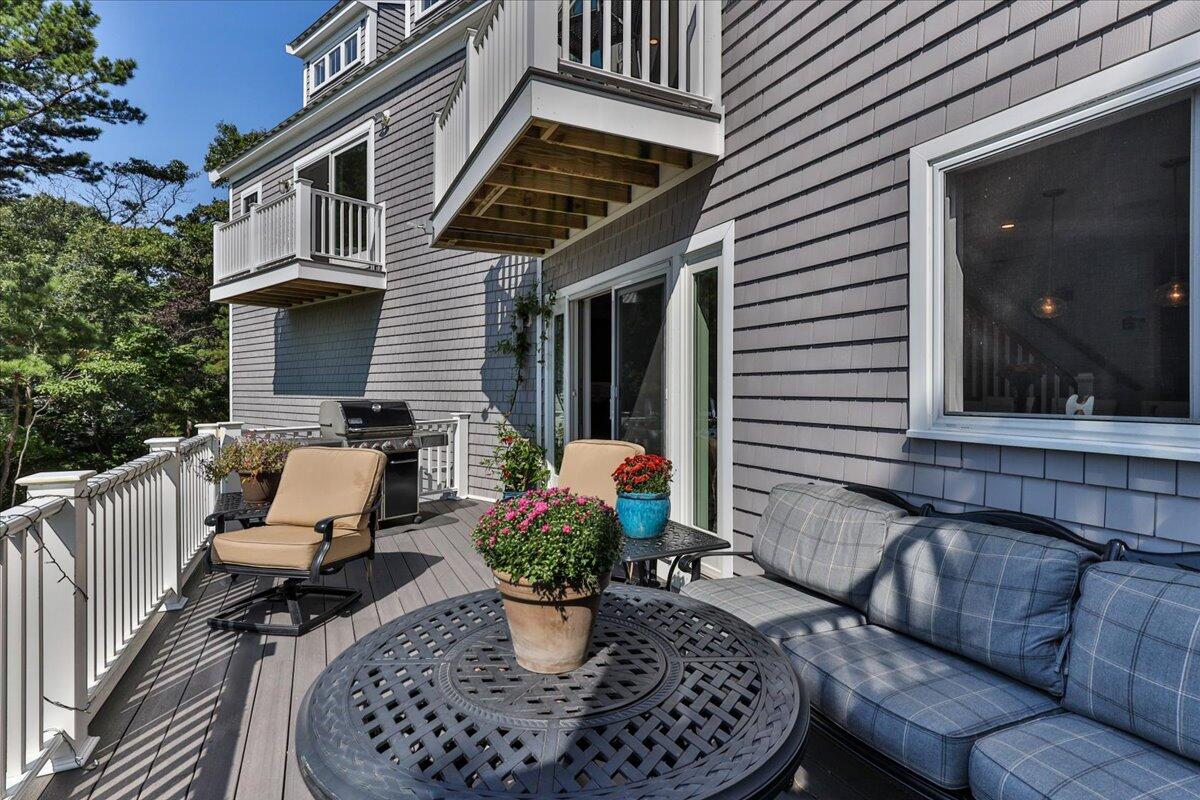 31 Amy Brown Road Mashpee, MA 02649 - Photo 66 of 95 a view of a patio with couches chairs and potted plants