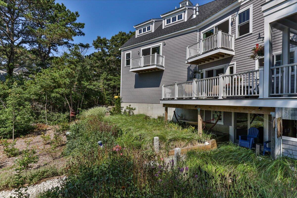 31 Amy Brown Road Mashpee, MA 02649 - Photo 68 of 95 a front view of a house with a garden