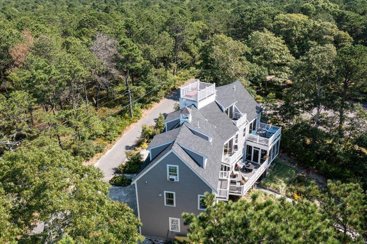 31 Amy Brown Road Mashpee, MA 02649 - Photo 78 of 95 an aerial view of a house with a yard and trees all around