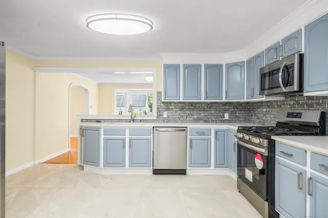 a kitchen with stainless steel appliances granite countertop a stove sink and cabinets