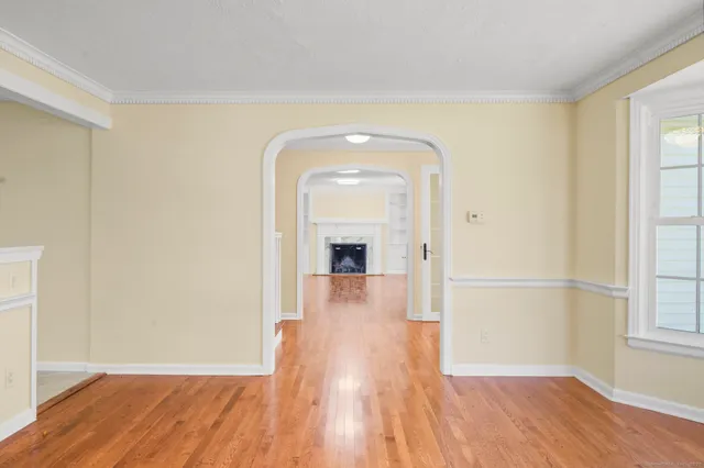 a view of a room with wooden floor and a ceiling fan