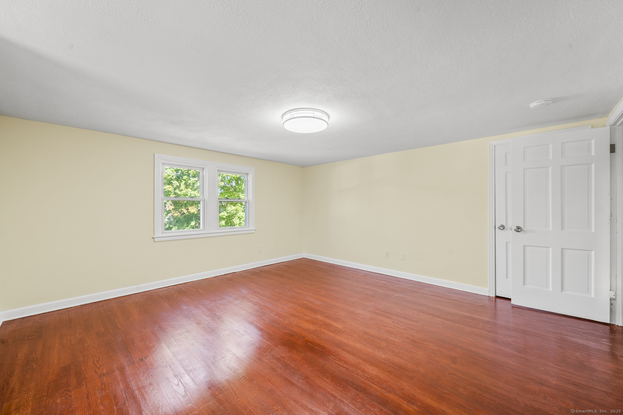 20 Rosina Road Hamden, CT 06514 - Photo 26 of 40 an empty room with wooden floor and windows