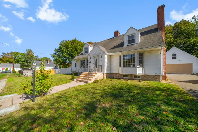 a front view of house with yard and outdoor seating
