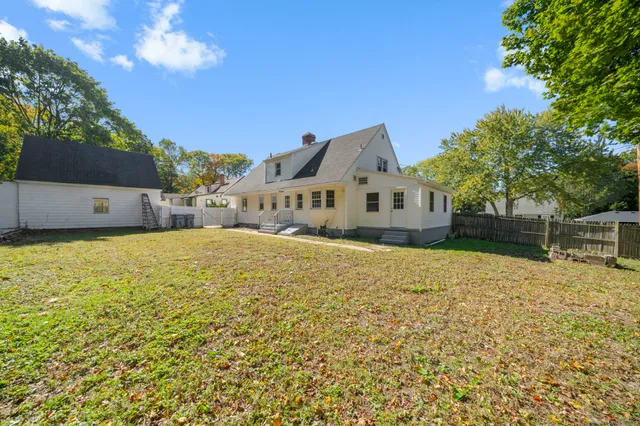 a large house with a large tree in front of it
