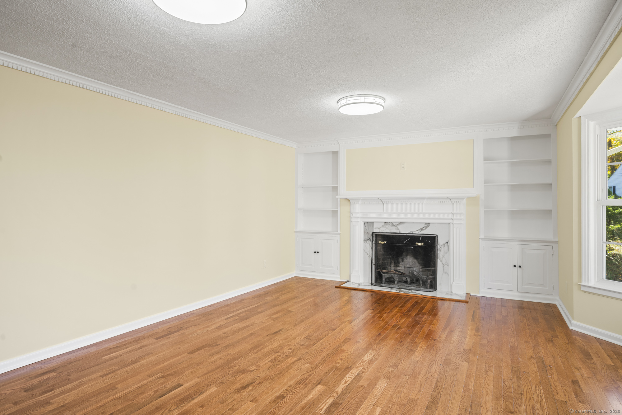 20 Rosina Road Hamden, CT 06514 - Photo 6 of 40 a view of an empty room with wooden floor and a window
