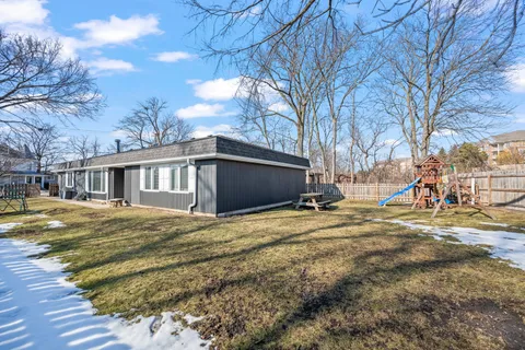 a view of a house with snow on the road