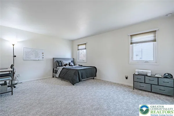 a bedroom with a bed and a lamp on table