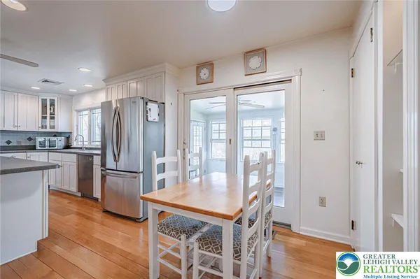 a kitchen with refrigerator cabinets and wooden floor