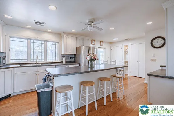 a large kitchen with a table and chairs