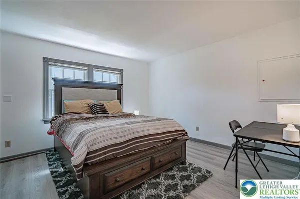 a bedroom with a bed and a table in it